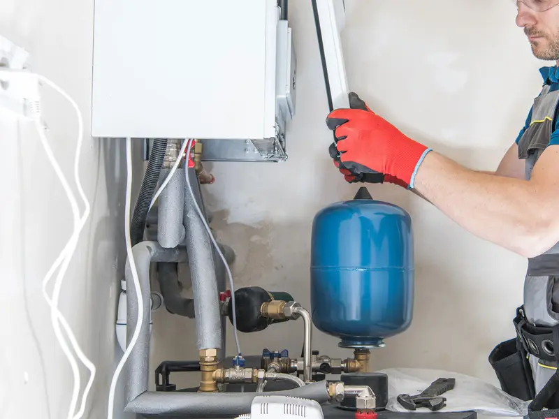 Gas engineer installing a central heating boiler System Servicing Lincoln