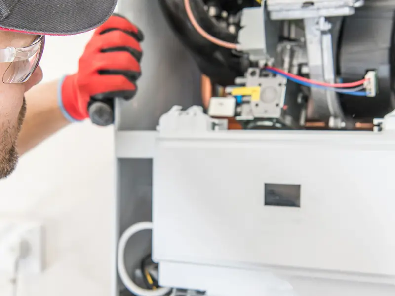 Gas engineer repairing a boiler System Servicing Lincoln
