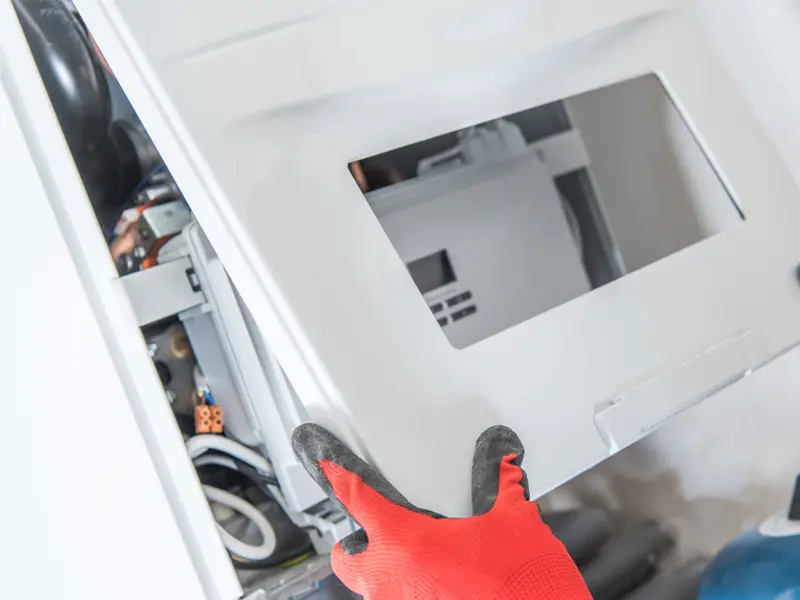 Engineer removing a boiler casing for repair System Servicing Lincoln